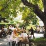 Danube-Rad-Hotel Gasthof Böhm, © Donau-Rad-Hotel Gasthof Böhm People sit outside under trees at tables and enjoy a meal.