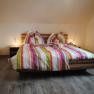 Room example Pension Wieselmayer, © Familie Wieselmayer Double bed with colorful striped bed linen