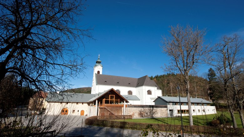 Pilgrimage church Klein-Mariazell, © Klein-Mariazell Pilgrimage church Klein-Mariazell with blue sky and trees in the foreground.