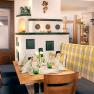 Guest room in the country inn in Marbach, © Engel OG Cozy restaurant interior with wooden table, stove and decoration.