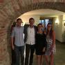 Böhm family, © Gasthof Böhm Four people stand smiling under a brick arch in a room with hunting trophies on the wall.