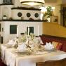 to the beautiful Viennese, © Engel Elegant restaurant with laid table and candles.