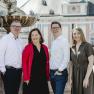 Leo and Brigitte Graf with son Andreas and daughter-in-law Birgit, © Niederösterreich-Werbung/David Schreiber Four people stand smiling in front of a fountain in an urban setting.