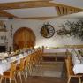 Gasthof Krenn, © zur Verfügung gestellt: Gasthof Krenn A festively decorated dining room with long tables, decorated with flowers and napkins, in a rustic ambience.