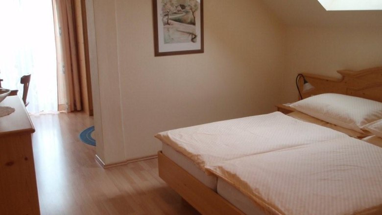 "Haus Karner" Guesthouse, © Pension "Haus Karner" Cozy bedroom with double bed, skylight and wooden furniture.