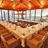 Gasthof Alpenblick, © Karl Hintersteiner Interior view of a restaurant with set tables and panoramic windows.