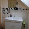 Bathroom, © Gerlinde Wieselmayer Modern bathroom with washbasin, mirror and mosaic tiles.