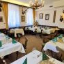 A traditionally decorated dining room with hunting trophies on the walls and laid tables.