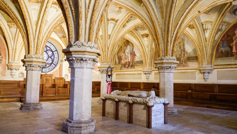 Interior view of the chapter house in Heiligenkreuz Abbey with Gothic vaults and a stone sarcophagus.