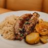 A plate of liver sausage, roast potatoes and sauerkraut.