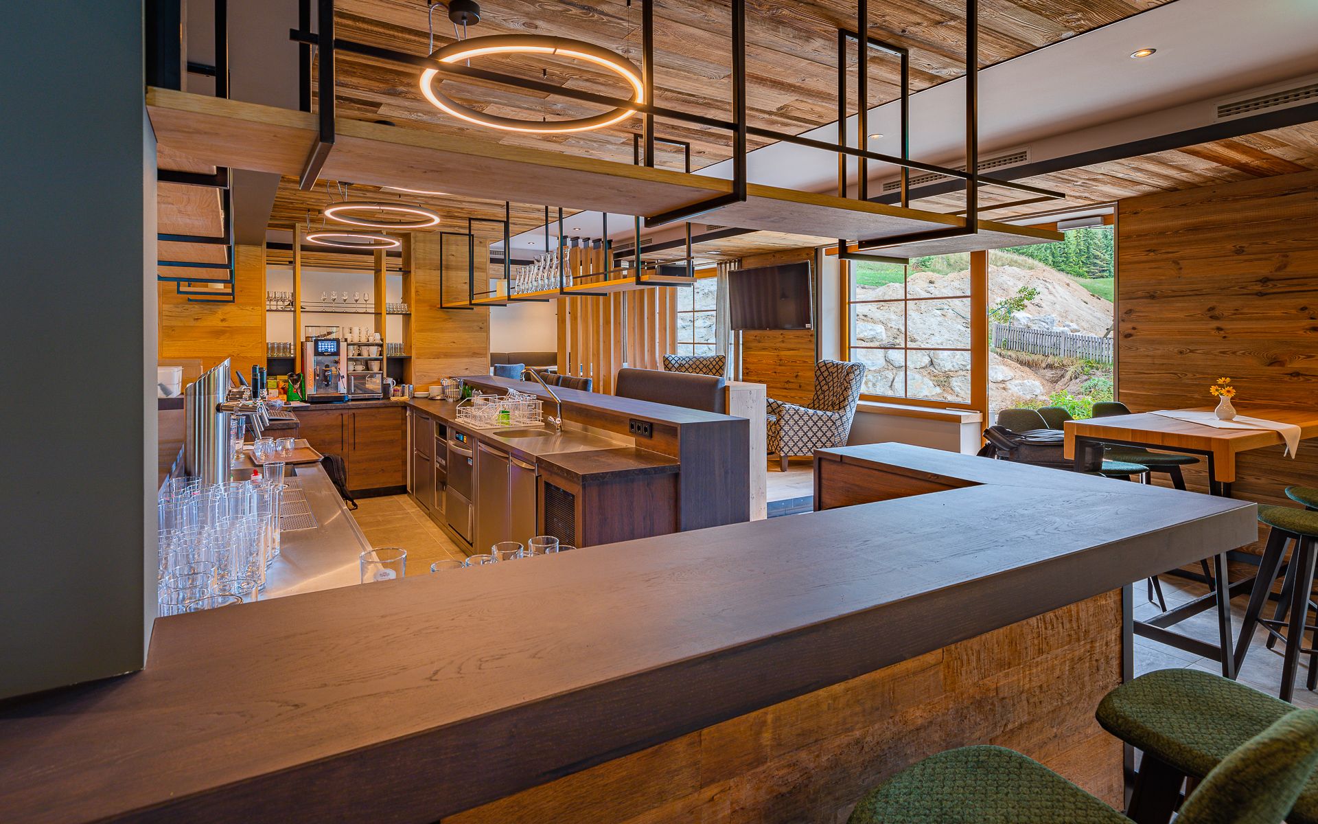 Modern restaurant with wooden decor and bar area.