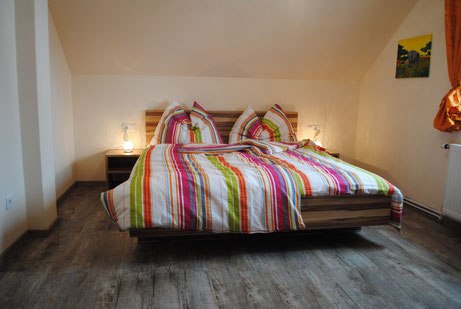 Double bed with colorful striped bed linen