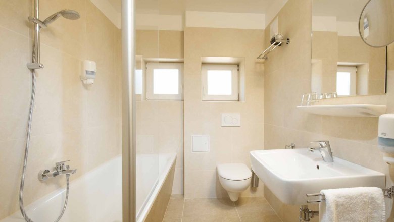 Modern bathroom with bathtub, washbasin and toilet.
