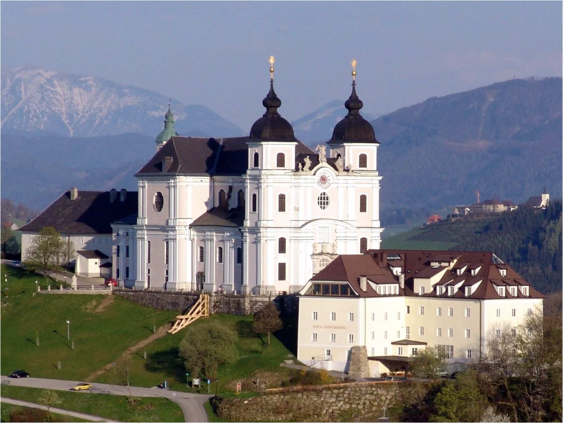 Sonntagberg basilica on a hill with mountains in the background.