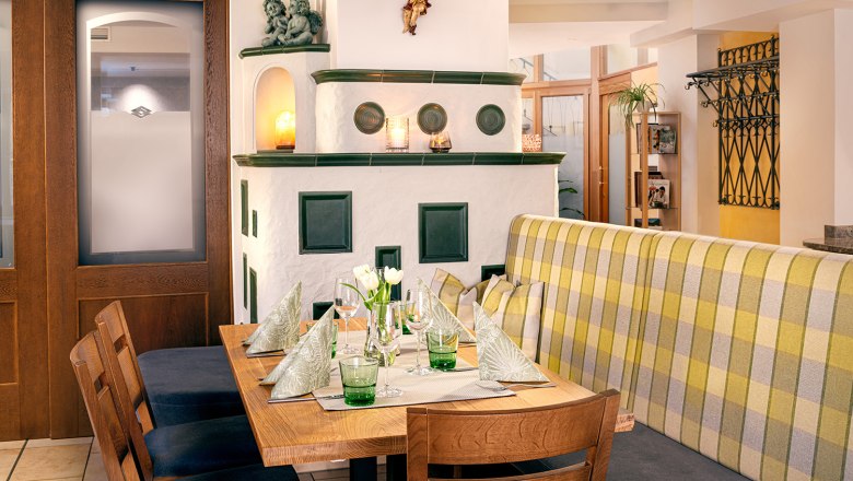 Cozy restaurant interior with wooden table, stove and decoration.