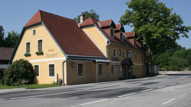Renzenhof Inn, © zVg Gasthof Renzenhof Yellow inn with a red roof on a road, surrounded by trees.