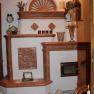 A decorative fireplace with ceramic ornaments and decorative objects.