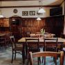 Cozy, traditional inn with wooden furniture and decorative pictures.