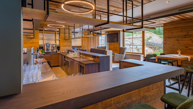 Modern restaurant with wooden decor and bar area.