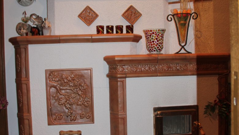 A decorative fireplace with ceramic ornaments and decorative objects.