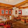 Cozy dining room with wooden furniture and red and white striped upholstery.