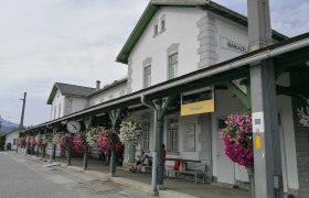Mariazell station with flowers and clock.