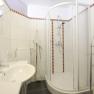 Modern bathroom with shower and washbasin.