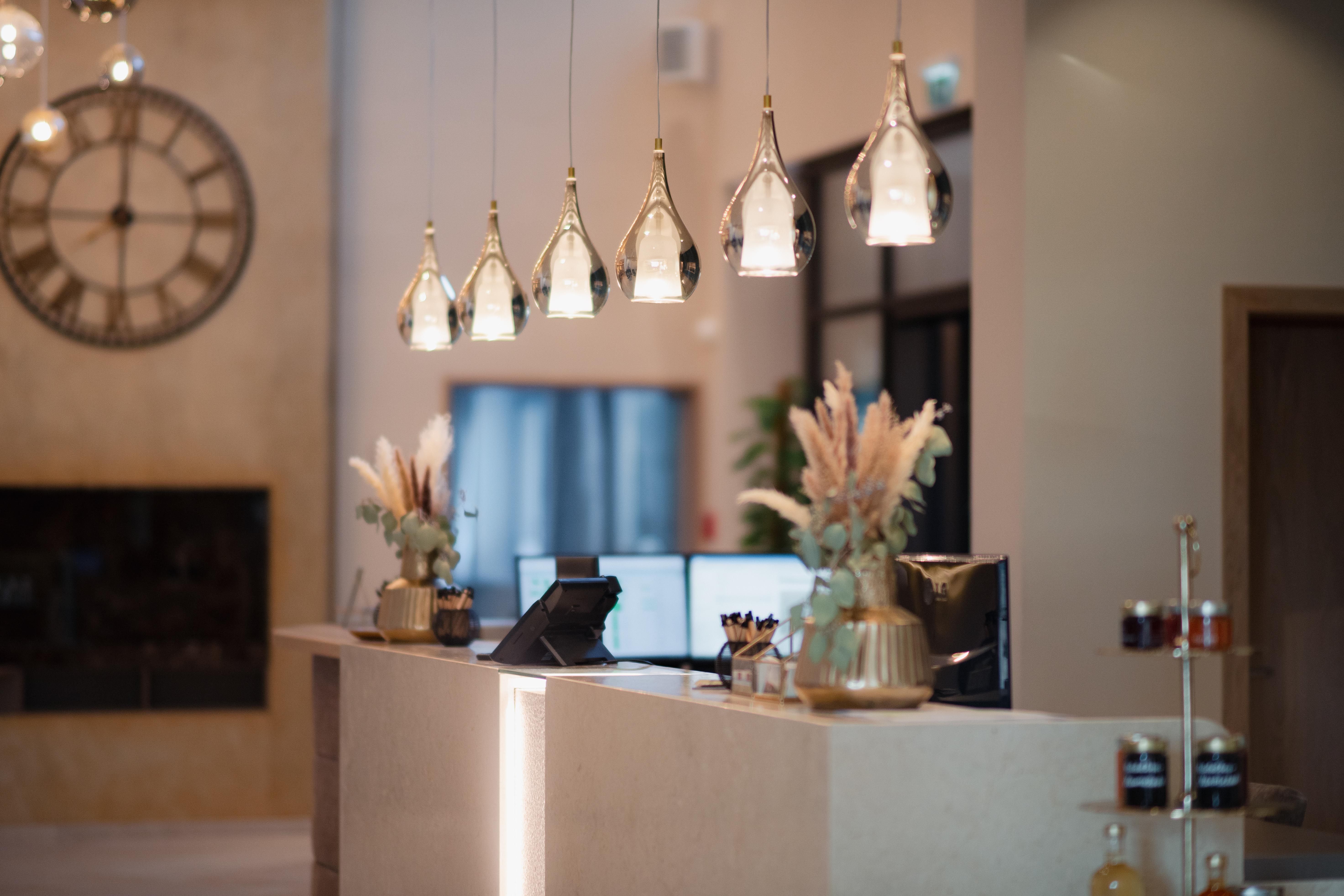 Elegant hotel reception with modern lamps and decorations.