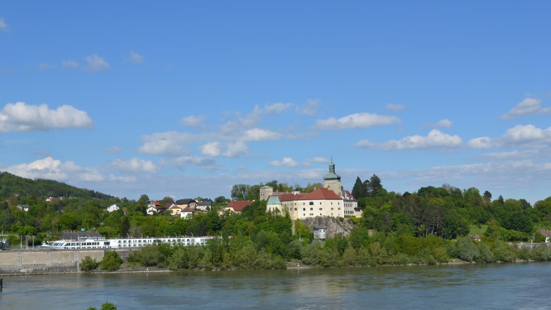 Persenbeug Castle and the surrounding area on a sunny day with a blue sky.