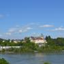 Persenbeug Castle and the surrounding area on a sunny day with a blue sky.